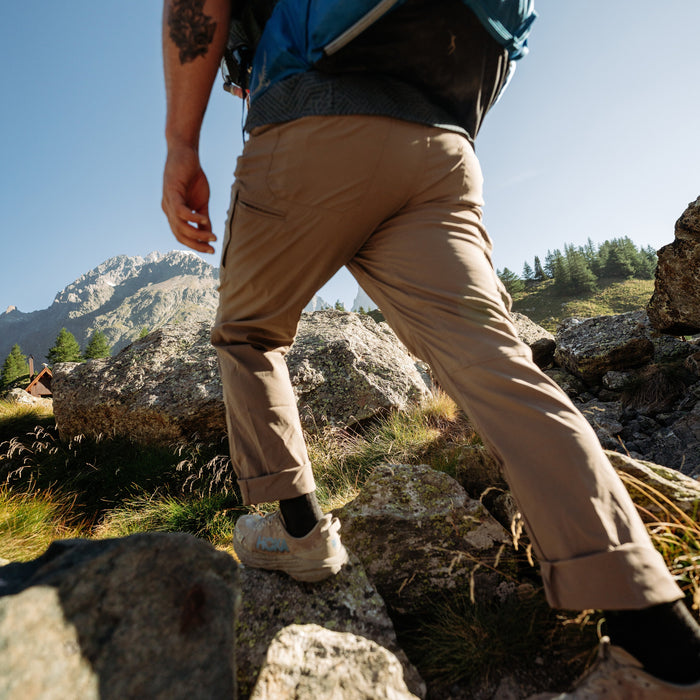 Kuhl Renegade Pant Buckskin Khaki - person hiking in the mountains - The Climbing Shop